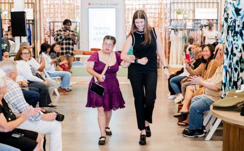 A PYD staff member walks a participant down the runway.